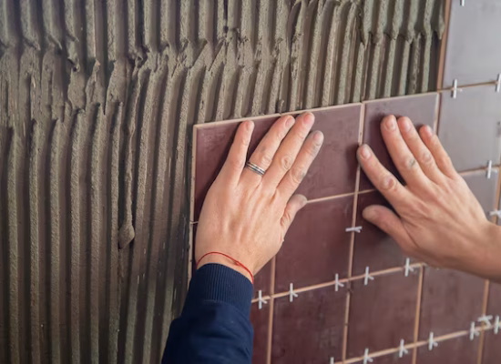 General Handyman Services master puts tile wall selective focus 511072 1365 1.avif