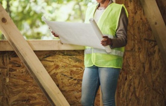 Services shot african female architect checking plans construction site new wooden house she is wearing protective workwear white helmet 360066 21349.jpg